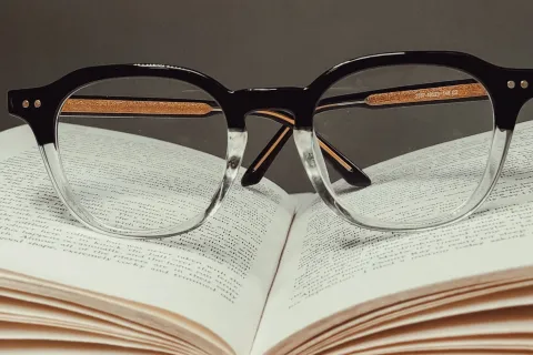 a pair of glasses on top of an open book