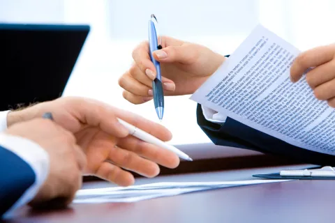 a person writing on a piece of paper