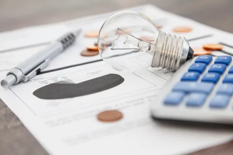 a calculator and a pen on a paper