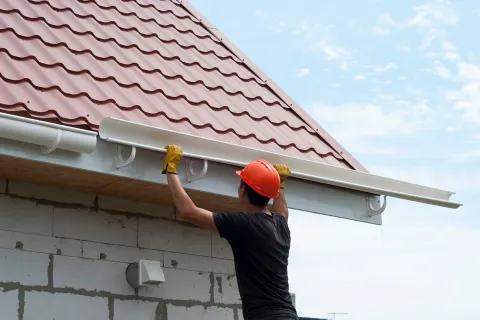 a person holding a gutter