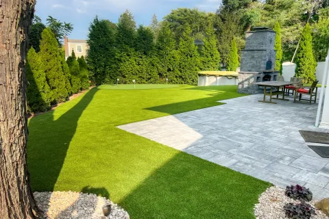 a backyard with a stone patio