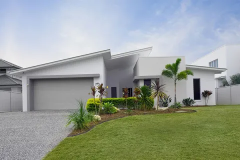 a white house with a green lawn