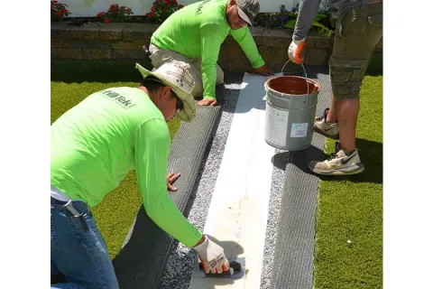 a few men working on a solar panel
