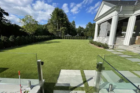 a backyard with a pool and a house