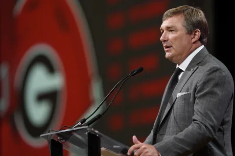 Kirby Smart speaking into a microphone
