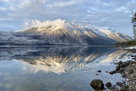 a lake with a snowy mountain in the background