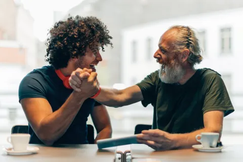a man and a woman looking at a tablet