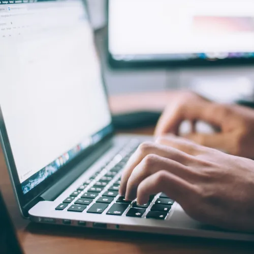 a person typing on a laptop