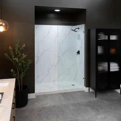 Modern bathroom with dark walls, marble shower, freestanding tub, black cabinet, and dual sink vanity.