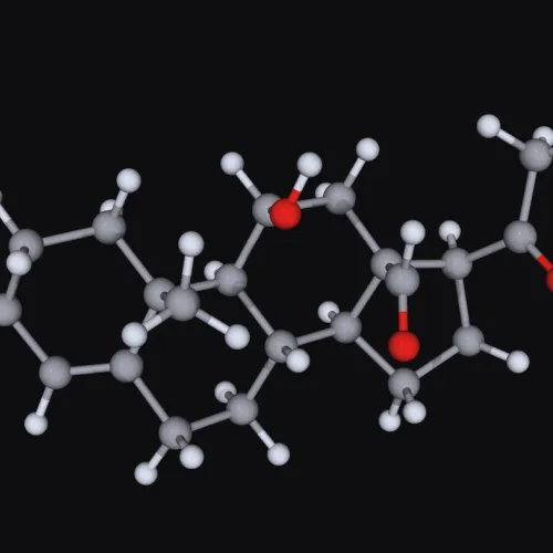 3D molecular model showing atoms with gray carbon, white hydrogen, and red oxygen on black background