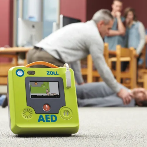 a person sitting on the floor next to a handheld game device