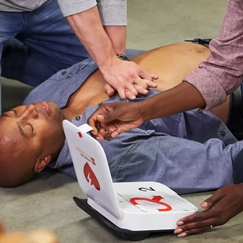 a man lying on the ground with a tablet