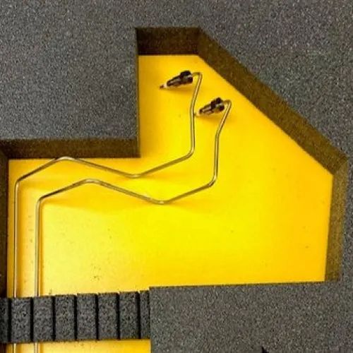 Metal wire-shaped tools placed in yellow foam with black protective foam surrounding them
