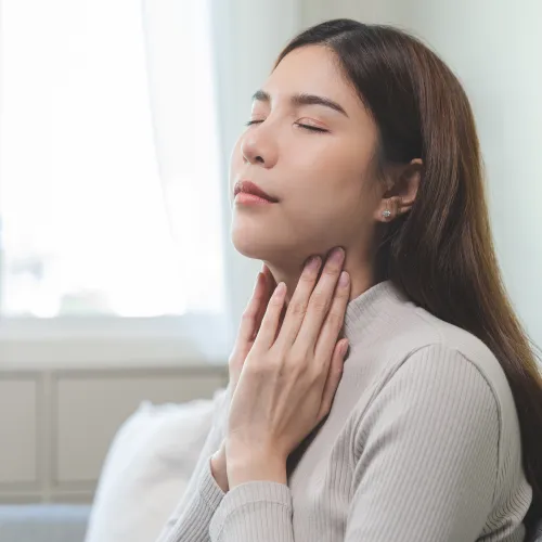 a woman with her hand on her face
