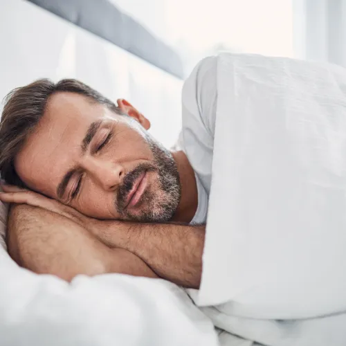 a man sleeping in a bed