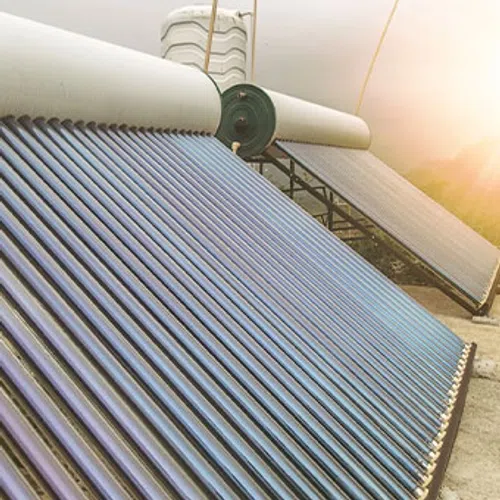 Close-up of solar water heating tubes under sunlight capturing solar energy for eco-friendly water heating.