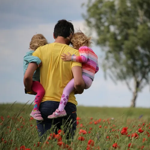 a person carrying a group of children