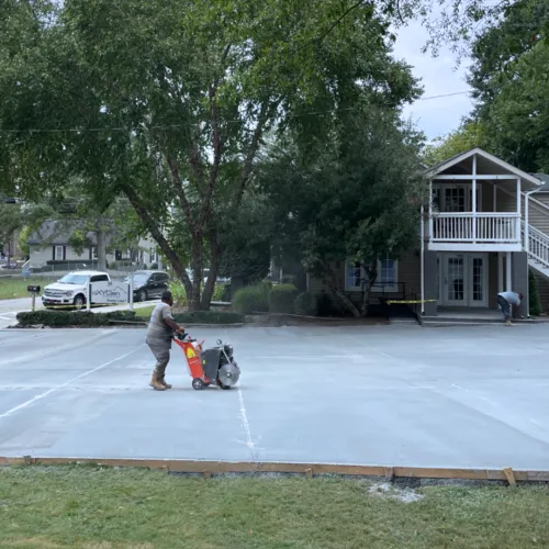 a person walking a dog in a parking lot