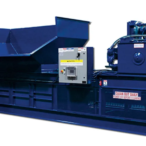 Large industrial horizontal baler machine used for compacting recyclable materials in factories and warehouses