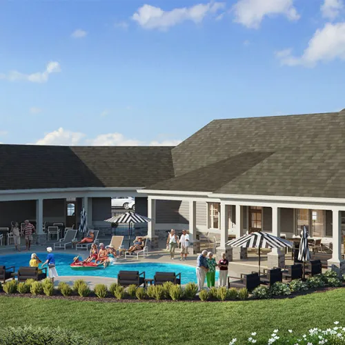 Modern clubhouse with outdoor pool, lounge chairs, umbrellas, and people enjoying a sunny day in landscaped garden.