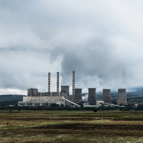a factory with smoke stacks