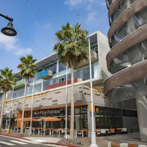 a building with palm trees and a street