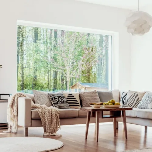 a living room filled with furniture and a big picture window