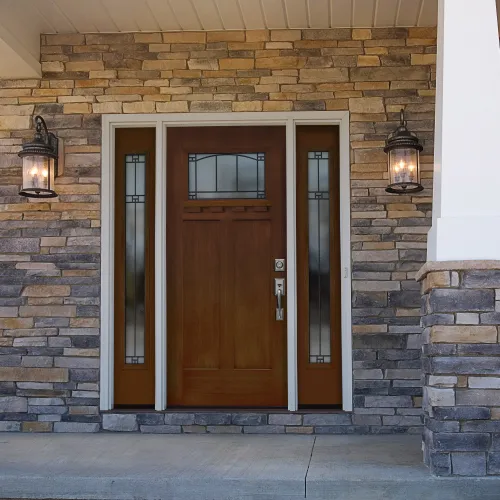 front porch of home with large brown door and pillars
