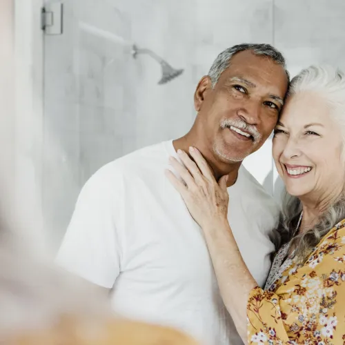 a man and a woman smiling for the camera