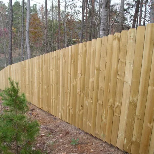 a wooden fence in a wooded area
