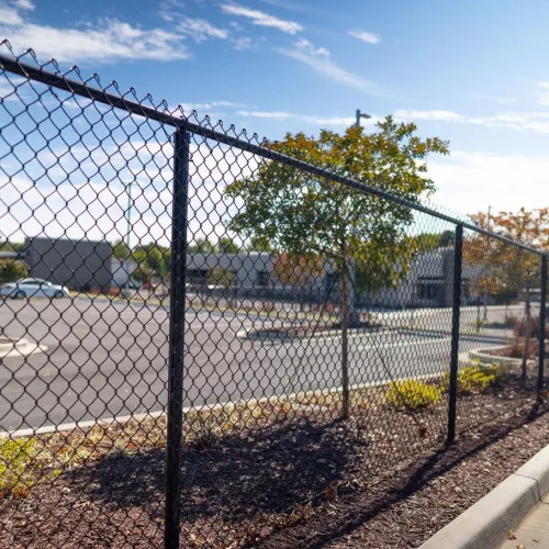 a fenced off area with a chain link fence and a street