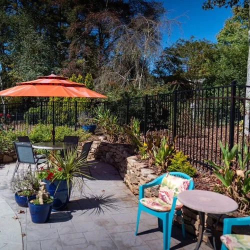 a patio with a table and chairs and umbrella