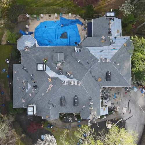 a house with a pool and people around it