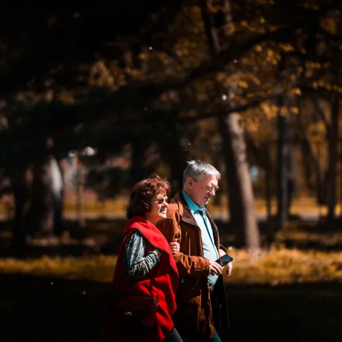 a man and woman standing in a park at night