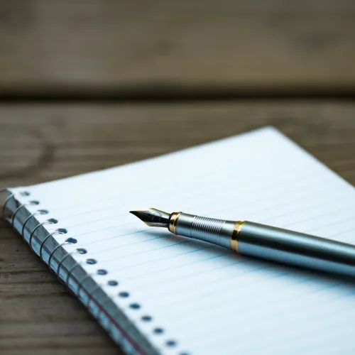 a pen and a paper on a table