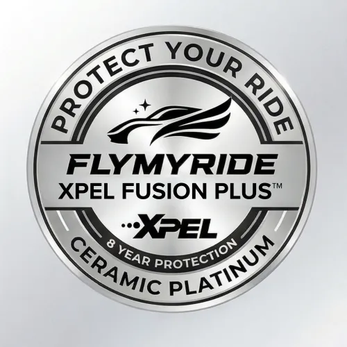 Close-up of hands using a polishing machine with white pad on a black car surface wearing black gloves.