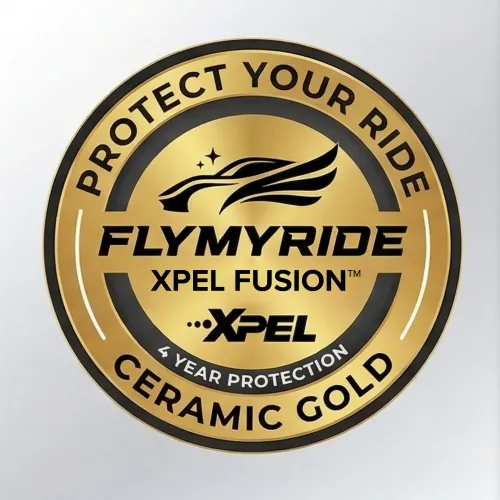 Person wearing black gloves polishing a glossy dark blue car surface with a white cloth.