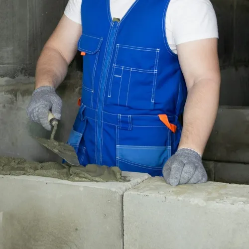 a person wearing a safety vest and gloves