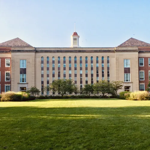 a large building with a lawn in front of it