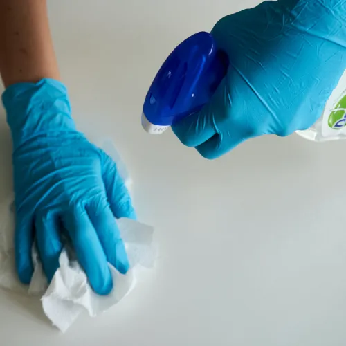 a person wearing gloves and cleaning