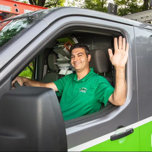 a man waving from a car