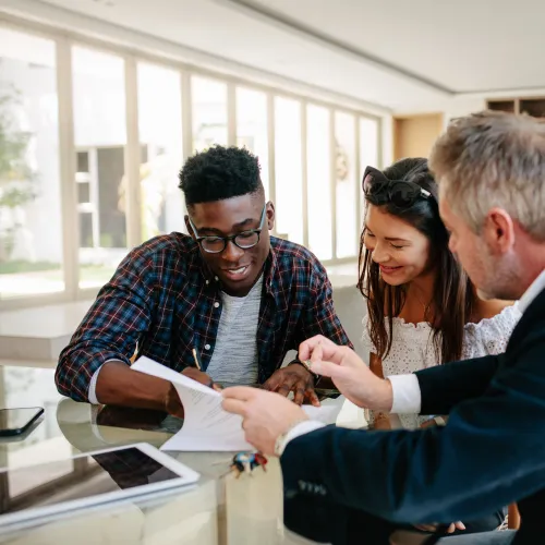 a group of people looking at a paper