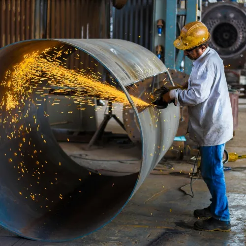 a person working on a large metal object