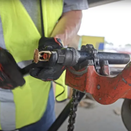 a person wearing a yellow safety vest working on a machine
