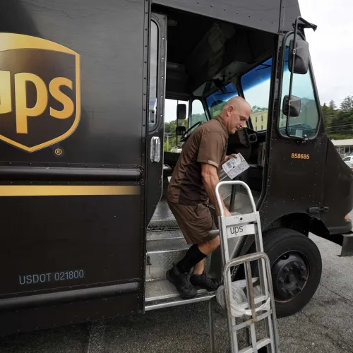 a man loading a truck with a ladder