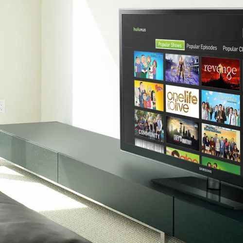 Modern living room with Samsung TV streaming popular TV shows from Hulu interface on screen.