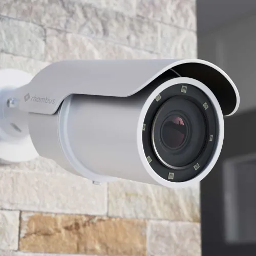 a white camera on a brick wall