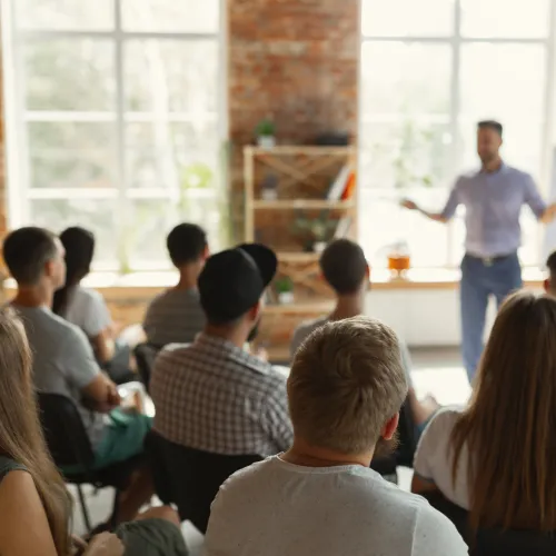 a woman addressing a group of people
