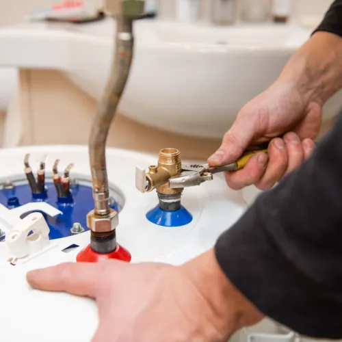 a person washing a sink