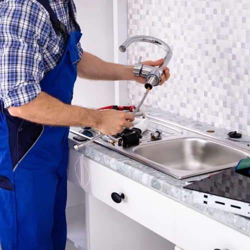 a man washing his hands in the sink